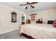 A well-lit bedroom featuring neutral walls, plush carpet, and a ceiling fan for a comfortable living space at 1657 10Th St, Danville, IN 46122