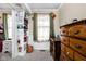 Bedroom featuring a built-in bookshelf, a window with curtains, and a charming desk area at 1657 10Th St, Danville, IN 46122