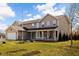 Charming two-story home with a welcoming front porch, attached garage, and a spacious green lawn in a residential setting at 1657 10Th St, Danville, IN 46122