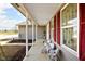 Inviting front porch featuring comfortable seating, red shutters and a serene view, perfect for relaxation and curb appeal at 1657 10Th St, Danville, IN 46122