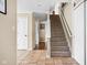 Entry hall featuring tile floors and a carpeted staircase leading to the upper level at 1657 10Th St, Danville, IN 46122
