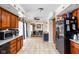 Bright kitchen featuring wooden cabinets, black appliances, and tile flooring at 1657 10Th St, Danville, IN 46122