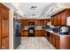 Kitchen with black appliances, wooden cabinets and hardware, and tile flooring at 1657 10Th St, Danville, IN 46122