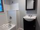 Bathroom featuring a vanity with a modern sink, framed mirror, and a bathtub with shower at 1900 E Purdue Rd, Muncie, IN 47303
