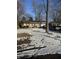 Cozy home featuring a snow-covered front yard and mature trees offering shade and privacy at 1945 N Audubon Rd, Indianapolis, IN 46218