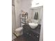 Cozy bathroom featuring a unique vessel sink, black countertop, and decorative shelving with stylish accessories at 2121 Grenville St # Apt 2A, Carmel, IN 46032