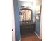 Charming bathroom with dark wood vanity, decorative glass sink, mosaic backsplash, and warm lighting at 2121 Grenville St # Apt 2A, Carmel, IN 46032