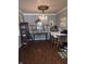 Elegant dining room with crystal chandelier, dark wood floors, mirrored buffet, and a mix of classic and contemporary decor at 2121 Grenville St # Apt 2A, Carmel, IN 46032