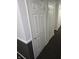 Hallway with multiple white doors and dark carpeting at 2121 Grenville St # Apt 2A, Carmel, IN 46032