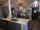 Open floor plan featuring a kitchen island, dining area with bar seating, and elegant decor, adjacent to the living space at 2121 Grenville St # Apt 2A, Carmel, IN 46032