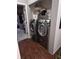 Modern laundry room featuring front loading washer and dryer set with storage above at 2121 Grenville St # Apt 2A, Carmel, IN 46032
