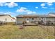 Fenced backyard featuring a wooden deck, fire pit, and manicured lawn at 2184 Galaxy Dr, Franklin, IN 46131