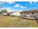 Fenced backyard with a wooden deck, fire pit, and grassy lawn at 2184 Galaxy Dr, Franklin, IN 46131