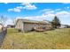 Grassy backyard with a wooden deck, fire pit, and fenced in area at 2184 Galaxy Dr, Franklin, IN 46131