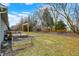 Grassy backyard with a wooden deck and fire pit at 2184 Galaxy Dr, Franklin, IN 46131