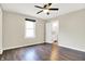 This bedroom offers a ceiling fan, dark wood floors, and view of the en suite bathroom at 2184 Galaxy Dr, Franklin, IN 46131