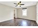 Bright bedroom features wood-look floors, a walk-in closet, a window, and a ceiling fan at 2184 Galaxy Dr, Franklin, IN 46131