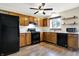 Traditional eat-in kitchen featuring wood cabinets, black appliances, and a window over the sink at 2184 Galaxy Dr, Franklin, IN 46131