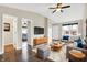 Staged living room features hardwood floors, a ceiling fan, a sofa, and plenty of natural light at 2184 Galaxy Dr, Franklin, IN 46131