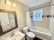 Well-lit bathroom with a shower-tub combo and rustic wood-framed mirror at 24 N Clay St, Mooresville, IN 46158