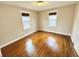 Bright bedroom with hardwood floors and two windows for natural light at 24 N Clay St, Mooresville, IN 46158