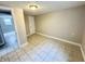 Versatile room with tiled floors and neutral walls, featuring a door and a window at 24 N Clay St, Mooresville, IN 46158