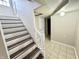 Staircase with neutral walls, tiled floors, and access to additional rooms at 24 N Clay St, Mooresville, IN 46158