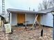 The covered back patio has some missing elements and boarded windows at 2513 W 10Th St, Muncie, IN 47302