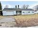 A single-story home with a one-car garage and a small front yard in need of maintenance at 2513 W 10Th St, Muncie, IN 47302