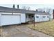 View of the front exterior showcasing the attached one-car garage and driveway at 2513 W 10Th St, Muncie, IN 47302