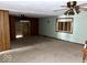 Empty living room featuring a decorative fireplace, built-ins, and a large window at 2513 W 10Th St, Muncie, IN 47302