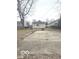 Spacious backyard with a concrete patio area and mature trees at 2526 Eastern Ave, Indianapolis, IN 46218
