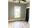 A cozy bedroom with modern flooring, a window for natural light, and a comfortable atmosphere at 2526 Eastern Ave, Indianapolis, IN 46218