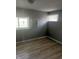 Standard bedroom featuring neutral walls, two windows and wood-look laminate flooring at 2526 Eastern Ave, Indianapolis, IN 46218