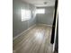 Standard bedroom featuring neutral walls, two windows and wood-look laminate flooring at 2526 Eastern Ave, Indianapolis, IN 46218