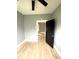 A bedroom featuring new flooring, a standard window for natural light, and a dark interior door at 2526 Eastern Ave, Indianapolis, IN 46218