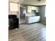 Clean, updated kitchen with neutral tones, laminate flooring, and modern appliances at 2526 Eastern Ave, Indianapolis, IN 46218