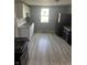 Well-lit kitchen with stainless steel appliances, laminate floor, and ample counter space at 2526 Eastern Ave, Indianapolis, IN 46218