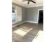 A living room with neutral tones, a window with blinds, and modern flooring at 2526 Eastern Ave, Indianapolis, IN 46218