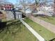 Aerial view of a backyard with a shed, wooden fence, green grass, and a walkway at 2528 Carrollton Ave, Indianapolis, IN 46205