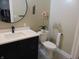 Stylish bathroom with dark vanity, black accents, and a circular mirror, creating a modern look at 2528 Carrollton Ave, Indianapolis, IN 46205