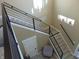 Entryway with modern staircase, wood-look tile floors, and decorative window cutouts at 2528 Carrollton Ave, Indianapolis, IN 46205