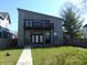 Modern two-story home featuring a balcony, minimalist landscaping, and a contemporary design at 2528 Carrollton Ave, Indianapolis, IN 46205