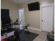 Home gym space with wood floors, neutral walls and an exercise bike at 2528 Carrollton Ave, Indianapolis, IN 46205