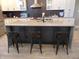 Modern kitchen island with barstool seating, stainless steel sink, and stylish countertops at 2528 Carrollton Ave, Indianapolis, IN 46205