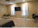 Main bedroom featuring a king bed, TV, windows and wood flooring at 2528 Carrollton Ave, Indianapolis, IN 46205