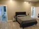 Main bedroom featuring a king bed, mirrored night stands and ensuite bathroom at 2528 Carrollton Ave, Indianapolis, IN 46205