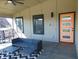 Covered porch featuring a modern door, sleek furniture, and stylish decor at 2528 Carrollton Ave, Indianapolis, IN 46205