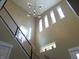 Bright staircase with a modern chandelier and numerous windows providing ample natural light at 2528 Carrollton Ave, Indianapolis, IN 46205