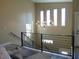 Bright staircase with a modern chandelier and windows providing ample natural light at 2528 Carrollton Ave, Indianapolis, IN 46205